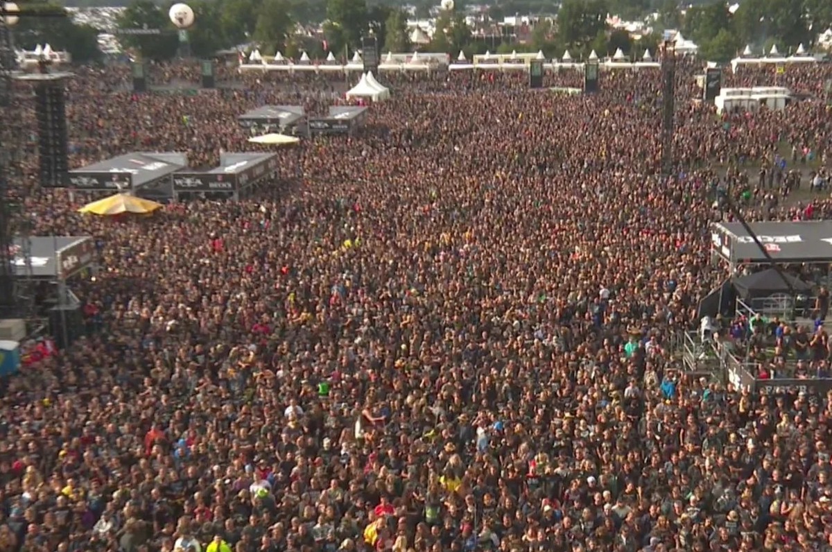Daytime drone point of view photograph of Wacken crowd.
